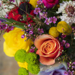 Colorful bouquet with roses and small purple flowers