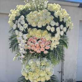 Large standing floral spray with white and blush roses and orchids