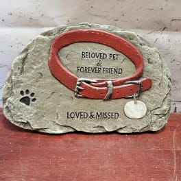 Pet memorial stone with a red collar and paw print