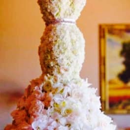 Tall tiered floral arrangement with white and pink flowers