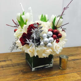White tulips and roses with red roses in a square vase