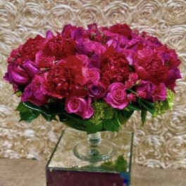 Pink and red rose arrangement in a clear glass vase