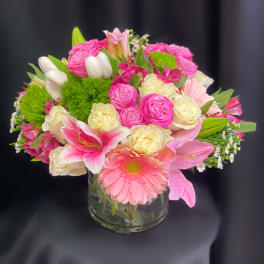 Pink and cream mixed bouquet in a clear glass vase