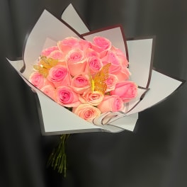 Bouquet of pink roses wrapped in white paper