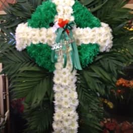 White and green floral cross arrangement with a ribbon bow