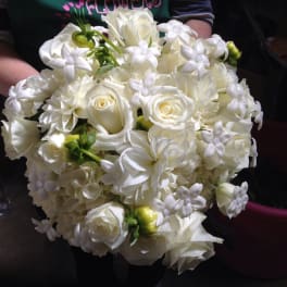 White rose and lily bouquet with small white filler flowers