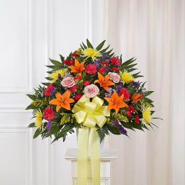 Large mixed flower arrangement with a yellow ribbon bow