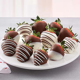 Plate of chocolate-covered strawberries with white drizzle