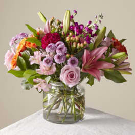 Mixed pink and purple bouquet in a clear glass vase