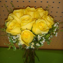 Bouquet of yellow roses with small white filler flowers