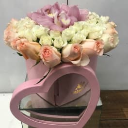Pink and white rose bouquet in a pink heart-shaped box
