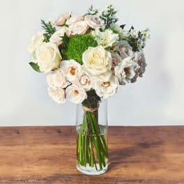 Cream and blush roses in a clear glass vase