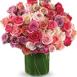 Bouquet of pink and lavender roses in a glass vase