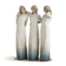 Three blurred figures in long white dresses standing together
