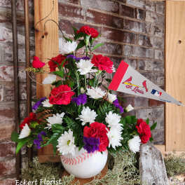 Baseball-themed floral arrangement in a white vase with a St. Louis pennant