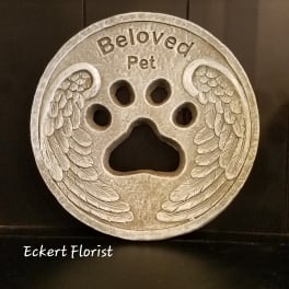 Round memorial plaque with a paw print and angel wings reading "Beloved Pet"