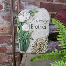 Decorative memorial stone with white tulips and the words "Loving Brother"