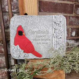 Decorative stone plaque with a red cardinal and floral accents