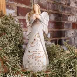 Angel figurine holding a heart with a memorial message