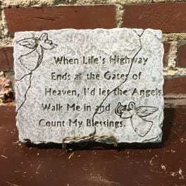 Stone plaque with engraved angels and a religious quote