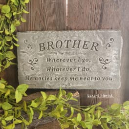 Stone memorial plaque engraved with the word Brother and a short verse