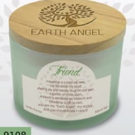 Green candle in a glass jar with a wooden lid and printed label