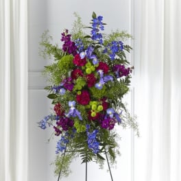 Tall standing floral spray with blue, purple, and pink flowers