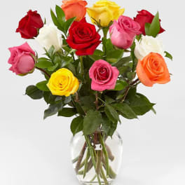 Bouquet of multicolored roses in a clear glass vase
