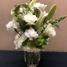White floral arrangement in a clear glass vase