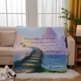 Printed blanket draped over a sofa with a rainbow staircase design