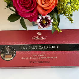 Bouquet above a box of sea salt caramels