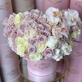 Pastel rose bouquet in a pink hat box with white orchids
