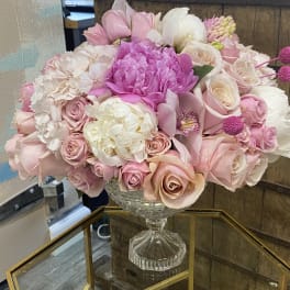 Pink and white floral arrangement in a clear glass vase