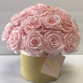 Pink rose bouquet in a gold round box with a hanging tag