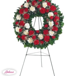 Red and white carnation wreath on a standing easel