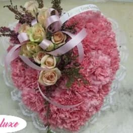 Pink carnation bouquet with cream roses and ribbon