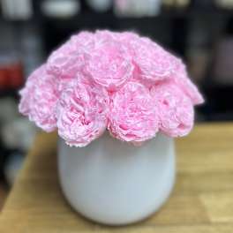Pink peonies arranged in a white vase