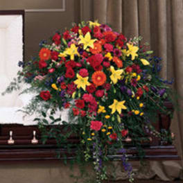 Large standing floral spray with red, yellow, and orange flowers