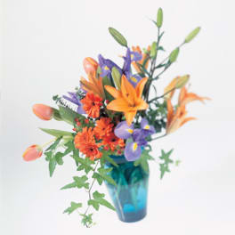 Orange and purple flowers in a blue vase