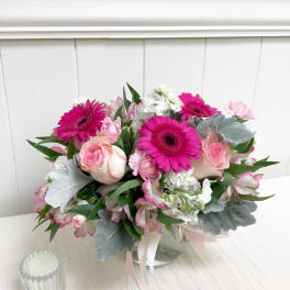 Pink and white bouquet with gerbera daisies and roses in a glass vase
