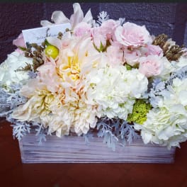 Pastel floral arrangement in a rectangular wooden box