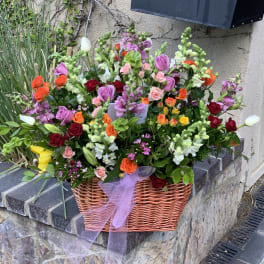 Large mixed flower basket with roses, tulips, and snapdragons