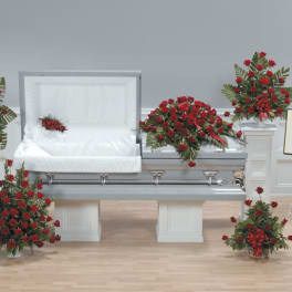 Red rose funeral casket spray with matching standing arrangements