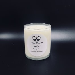 White soy wax candle in a clear glass jar with a printed label