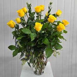 Yellow roses arranged in a clear glass vase