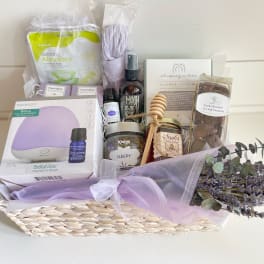 Gift basket with lavender items, chocolates, and a small lavender bouquet