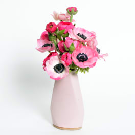 Pink anemones arranged in a pale pink vase