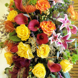 Large bouquet with yellow roses, burgundy calla lilies, and pink lilies