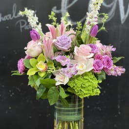 Mixed pink and lavender bouquet in a clear glass vase