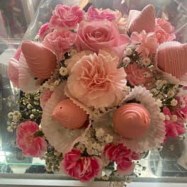 Pink bouquet with roses, carnations, and small white filler flowers